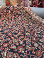 Dark navy blue field Persian rug with small-scale fish motifs.