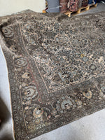 Mocha and espresso tones in antique rug design.