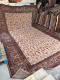 Antique Persian Mahal rug in palace size 13x20 with an allover floral pattern on a blush ground.