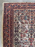 Low pile Persian rug showing age and natural wear.