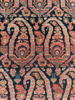 Close up view of colorful paisley layout on narrow rug.