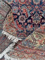 Low pile, handwoven Mahal rug with refined traditional design.