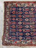 Navy animal motif Persian rug with colorful flowers, birds and village symbolism.