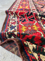 Detail of crab motif on fiery red ground.