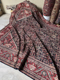Decorative border of Persian rug with serrated leaves on red ground