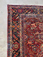 Subtle fading and wear on wool pile of antique rug.