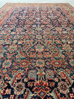 Detail of repeating Herati fish design on antique Persian rug.