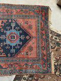 Another end view of antique rug showing tribal motifs and vegetable dyed wool.