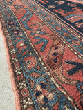 Border detail of antique Malayer rug with tribal symbols and natural dyes.