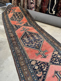 Antique runner with geometric border and earthy vegetable dye palette.