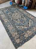 Antique Malayer rug with navy field and soft camel color border detailing.