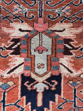 Close up of tribal design pattern of antique Persian Heriz rug.