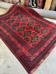 Antique mid-century Afghani rug with bold red ground and tribal medallion lattice design.