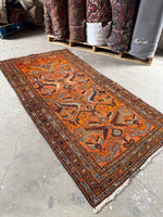 Orange Fever Persian rug from 1940, handwoven by Kurdish women.