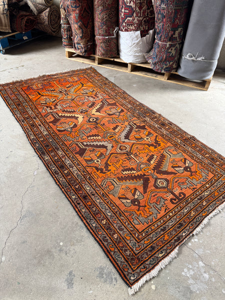 Orange Fever Persian rug from 1940, handwoven by Kurdish women.