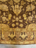Border detail of vintage Agra rug with soft floral motifs.