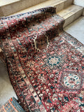 Northwest Persian tribal runner with faded vegetable dyes and strong village woven character.
