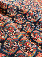 Close up of vibrant paisley patterns in blues, pinks, and greens.