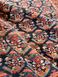 Close up of vibrant paisley patterns in blues, pinks, and greens.