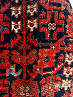 Midnight blue Persian runner with bold red and ivory motifs.