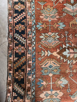 Traditional Heriz carpet with midnight blue serrated leaf border