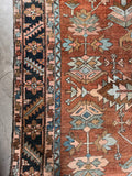 Traditional Heriz carpet with midnight blue serrated leaf border