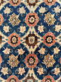 Close view of Mina Khani floral motifs in an antique 1940s Persian Veramin wool rug.