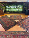 Antique Persian Malayer rug laid out with rich pink abrashed field and soft aged wool.