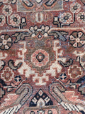 Close up of terracotta and blue Persian rug.