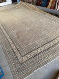 Diagonal view of large antique Seraband rug with repeating paisley pattern