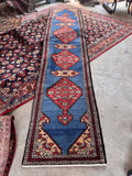 Narrow vintage Persian runner rug with rare French blue ground and geometric medallions.