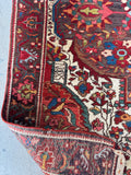 Vintage area rug showing low pile texture and solid weighted weave construction.