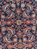 Vintage Persian rug showing Mahi design with age and character in rich colors.
