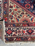1920s Persian rug with wheat spandrels and ivory turtle border.