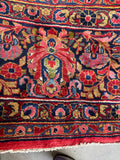 Navy border with intricate floral motifs on Persian rug