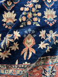 Detailed view of vegetable dyed wool and floral motifs in Sarouk rug.