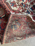 Underside view of antique Persian rug with vegetable dyed wool that has been handwoven.