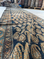 Close-up of low pile wool with paisley and botanical motifs.