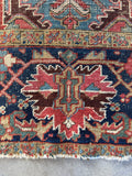 Closeup of navy border with turtle motifs on Persian Heriz rug.
