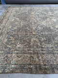 Side angle of antique Kerman rug showing age and craftsmanship.