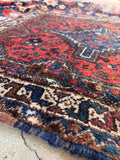 Antique Persian Baluch throw rug showcasing authentic 1940s nomadic textile art.