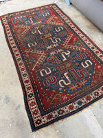 Antique Cloud Band Kazak rug with bold medallions and curlicue motifs.