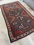 Antique Cloud Band Kazak rug with bold medallions and curlicue motifs.