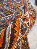 Vintage Persian tribal rug with a bold central medallion and detailed floral borders.