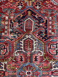 9x12 vintage Persian Heriz rug, bold geometric tribal rug with rich red, navy, ivory, and sky blue tones.