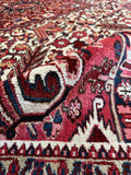 Heavy and durable antique Heriz rug with geometric tribal motifs throughout.