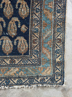 Corner view of Ice blue and caramel details in a worn Persian hallway runner.