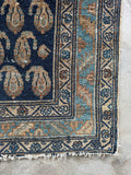 Corner view of Ice blue and caramel details in a worn Persian hallway runner.