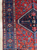 Handwoven 1920s Persian Malayer rug with soft old wool, tribal forms, and rich vegetable dyed colors.