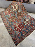Antique Caucasian rug with six hexagonal medallions on a French blue ground with visible abrash.